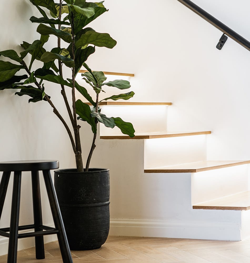 A close-up of a newly renovated staircase, with a touch of Scandinavian inspiration in a modern Spanish home.